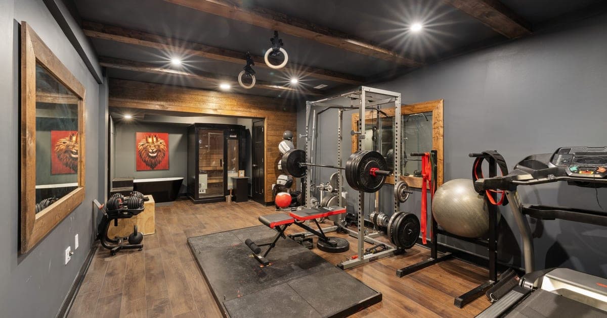 Row of treadmills beside a loaded weight rack in a gym, illustrating how long to leave between cardio and lifting